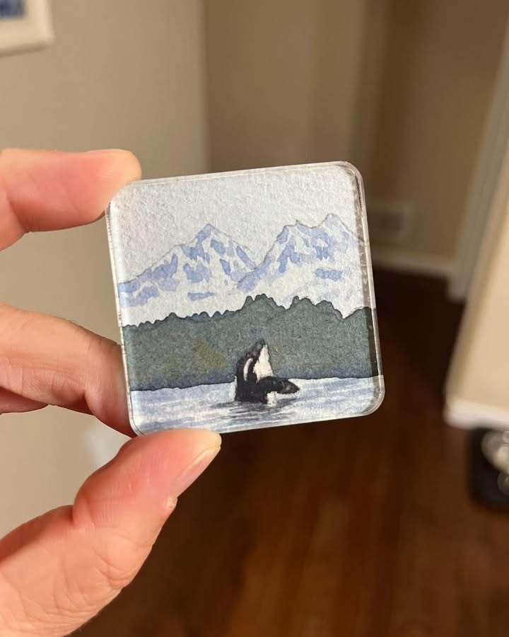 Painted pin of a photograph of an orca in Alaska. (© Jessica Schmidtbauer)